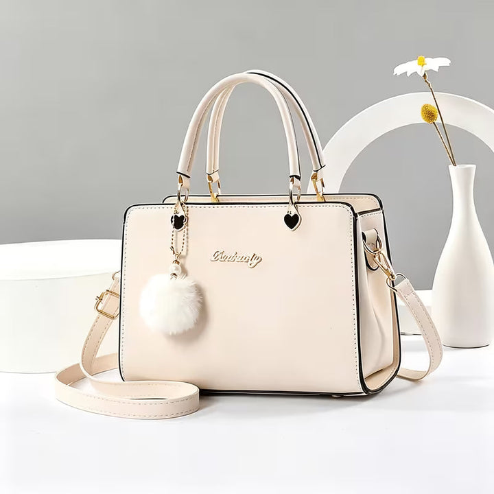 Sanika – Handtasche Mit Pompon Anhänger Und Schulterriemen